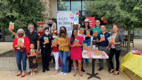 A group of people hold up copies of The House on Mango Street